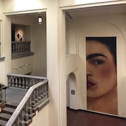 staircase at Heard Museum with large portrait of Frida Kahlo on the wall